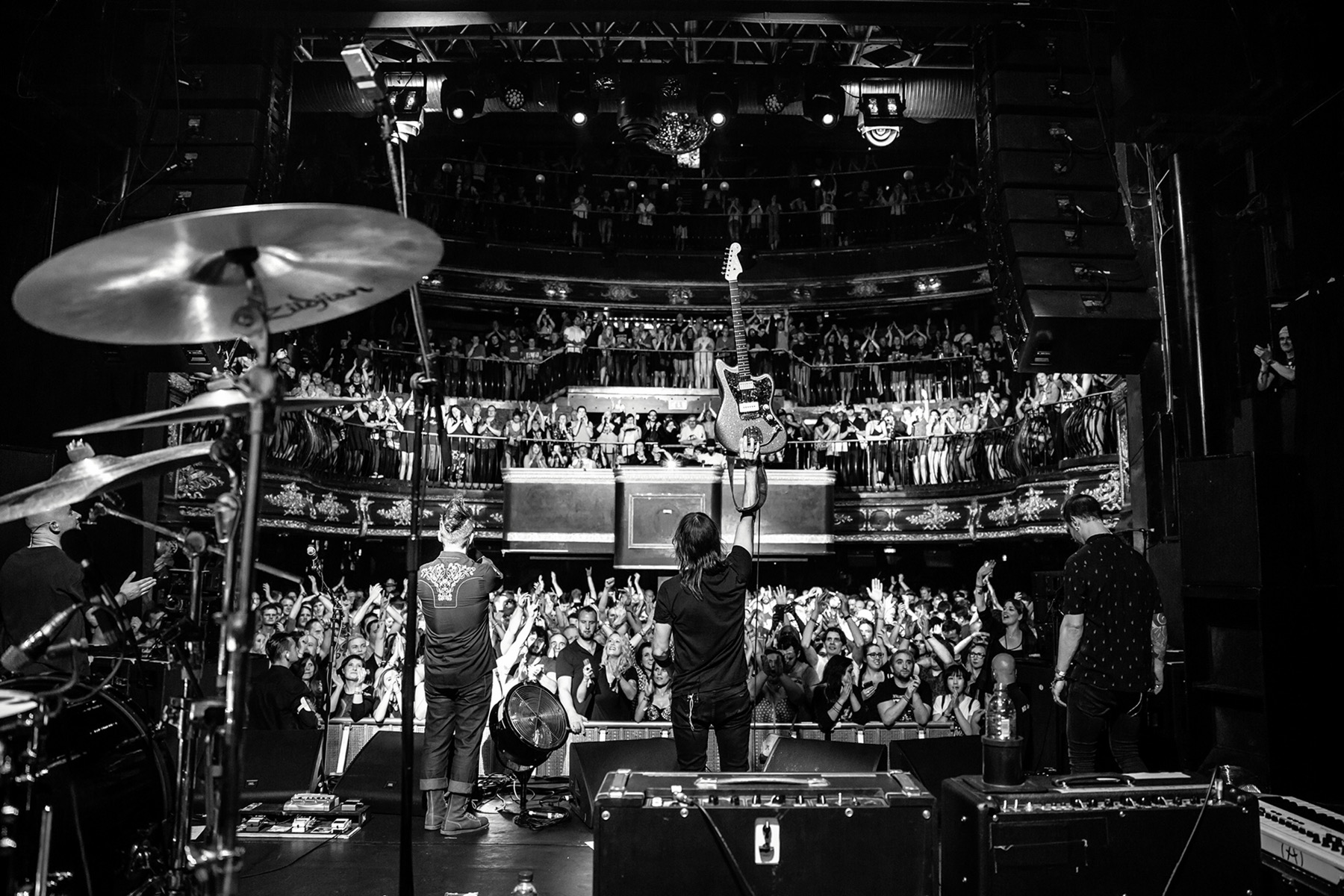 A band on stage facing a full venue at Camden Rocks